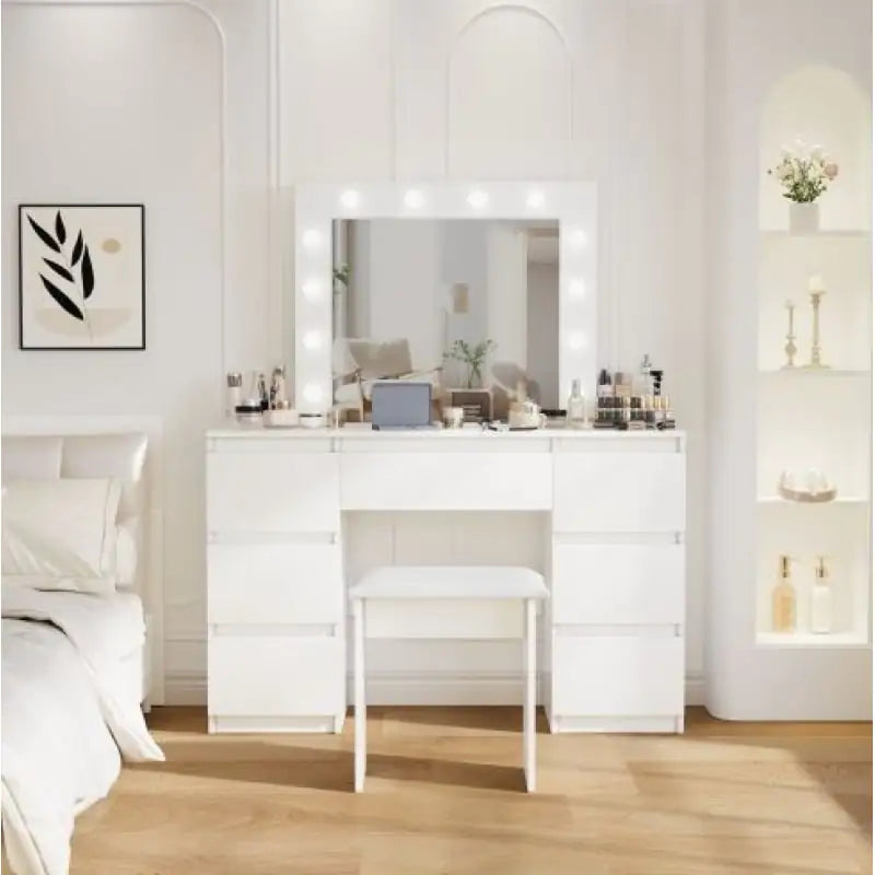 White vanity table with mirror and lights in a bedroom setting