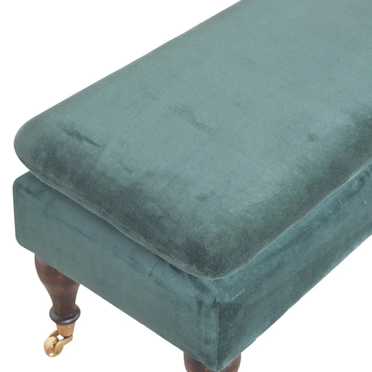 close up of emerald velvet upholstery and castor wheel leg