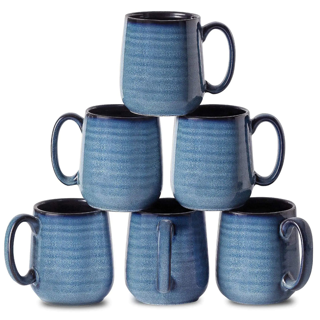 Stack of six blue ceramic mugs on a white background