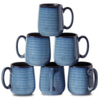 Stack of six blue ceramic mugs on a white background