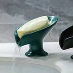 Green soap dish with bar of soap on a sink