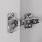 Metallic hinge attached to a gray surface