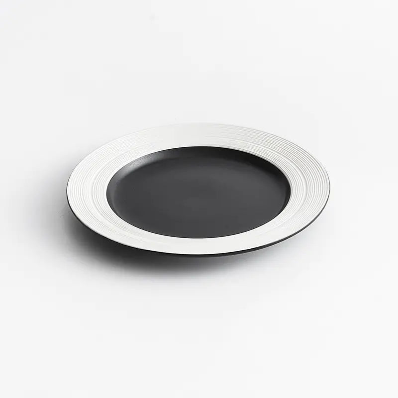 Black plate with white rim on a light gray background